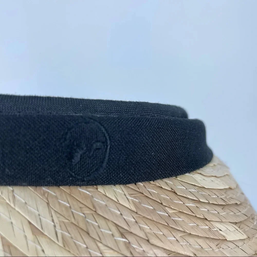 Straw visor with black trim.  Terry cloth lining